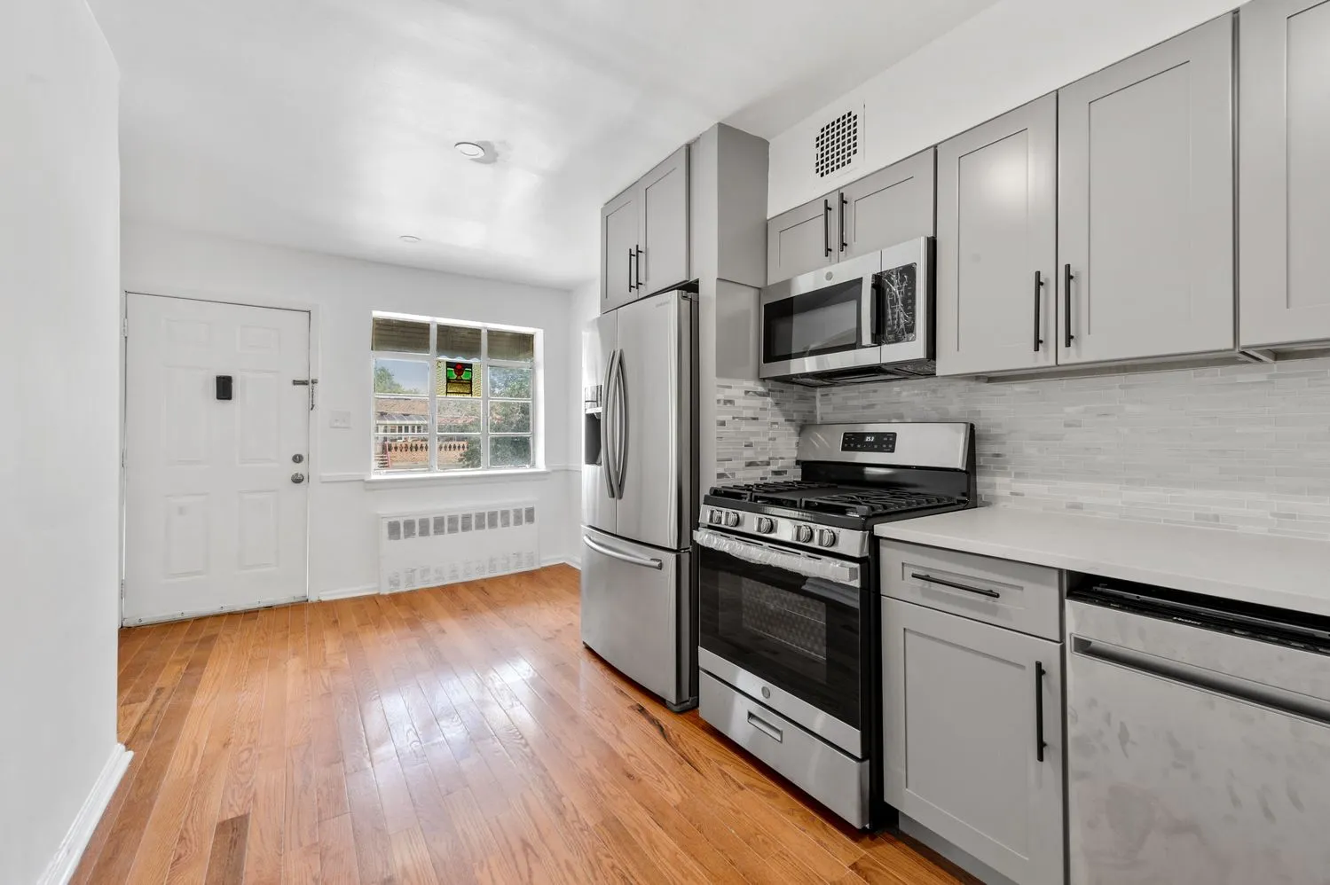 a kitchen with stainless steel appliances granite countertop a stove a sink and a microwave