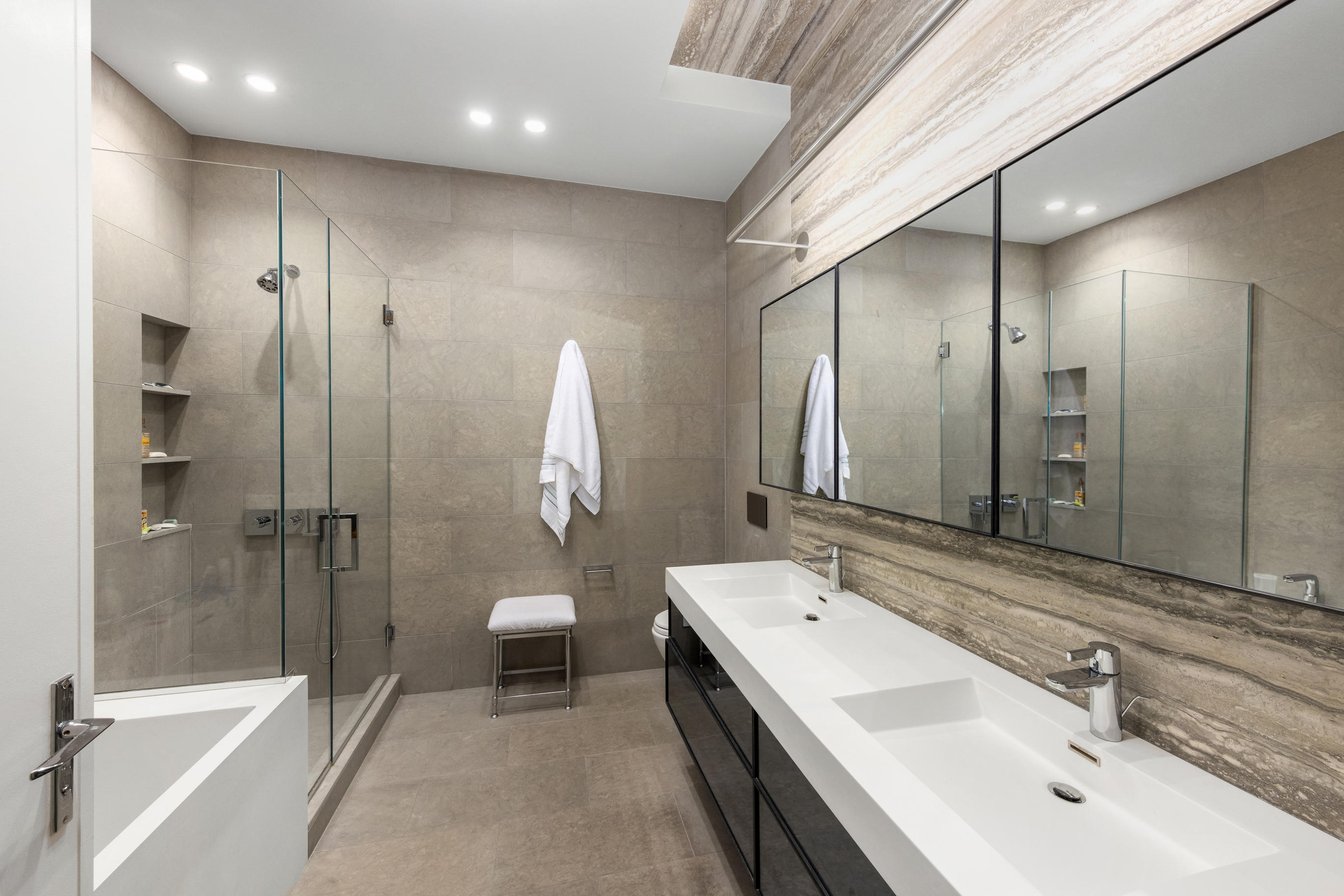 88 Lexington Avenue, Unit 1606 Manhattan, NY 10010 - Photo 15 of 20 a bathroom with a double vanity sink mirror and toilet