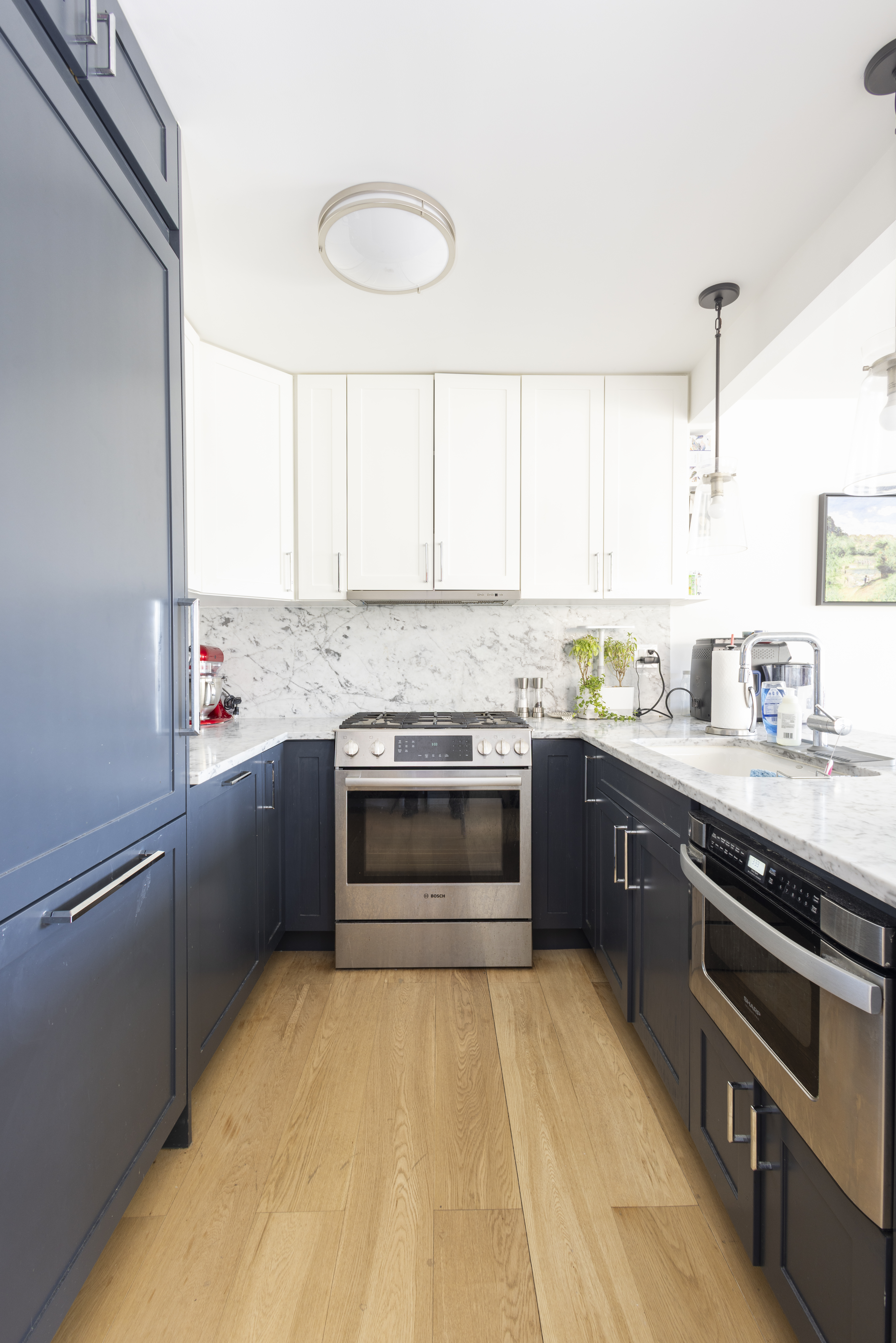 1330 5th Avenue, Unit 6C Manhattan, NY 10026 - Photo 5 of 16 a kitchen with granite countertop a stove sink and cabinets