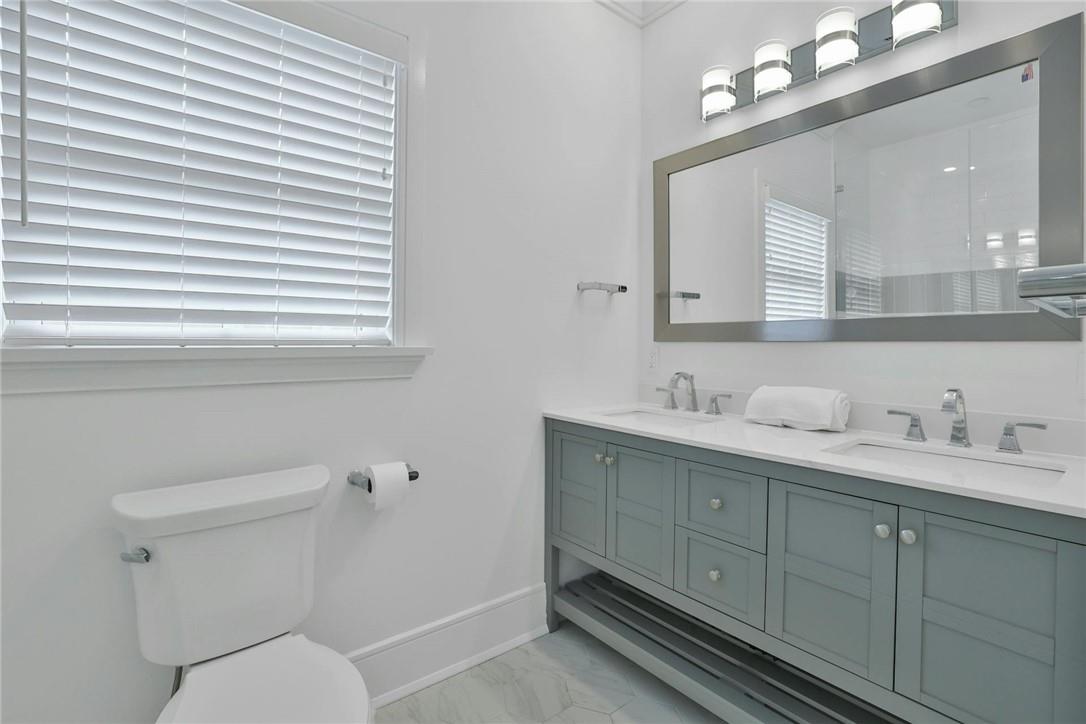 211 Purchase Street, Unit A Rye, NY 10580 - Photo 14 of 22 a bathroom with a toilet a sink a mirror a vanity and window