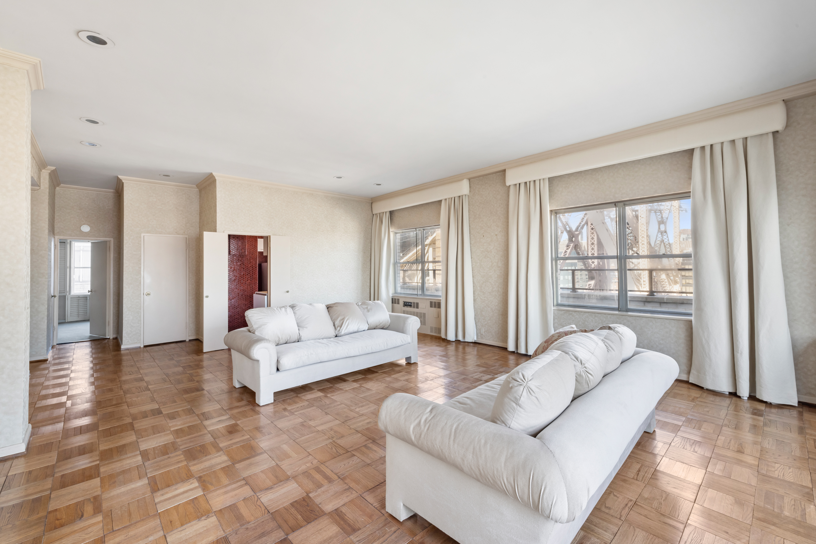 35 Sutton Place, Unit PHB Manhattan, NY 10022 - Photo 3 of 14 a living room with furniture and a large window