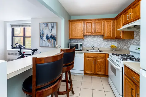 a kitchen with stainless steel appliances granite countertop a stove a sink dishwasher and a refrigerator
