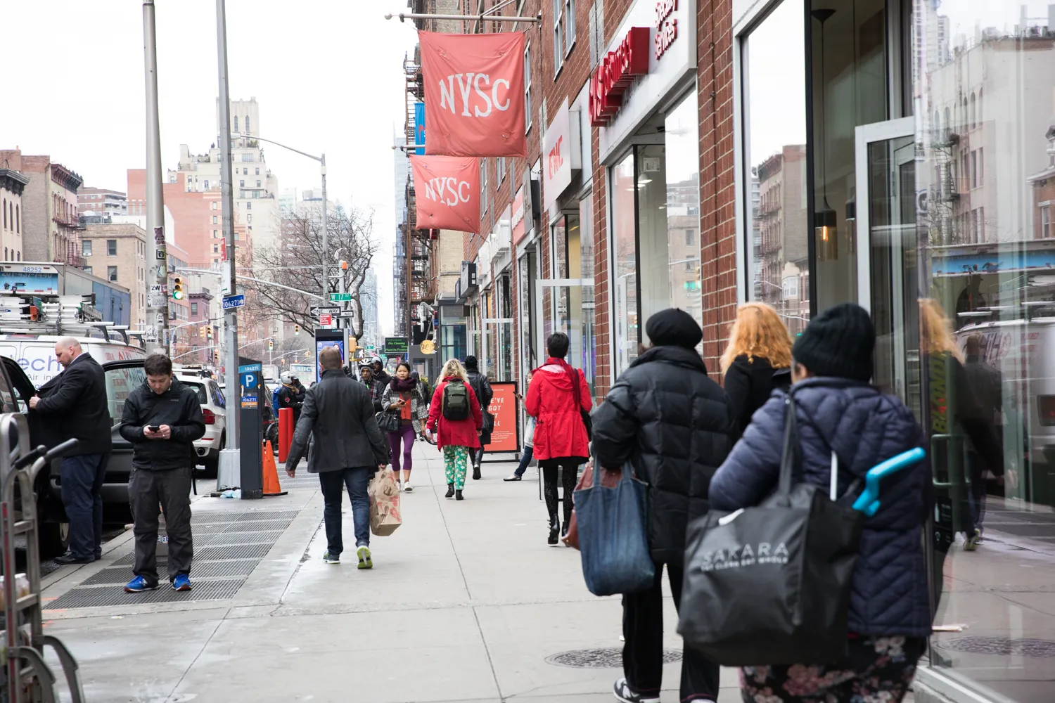a group of people walking down a street