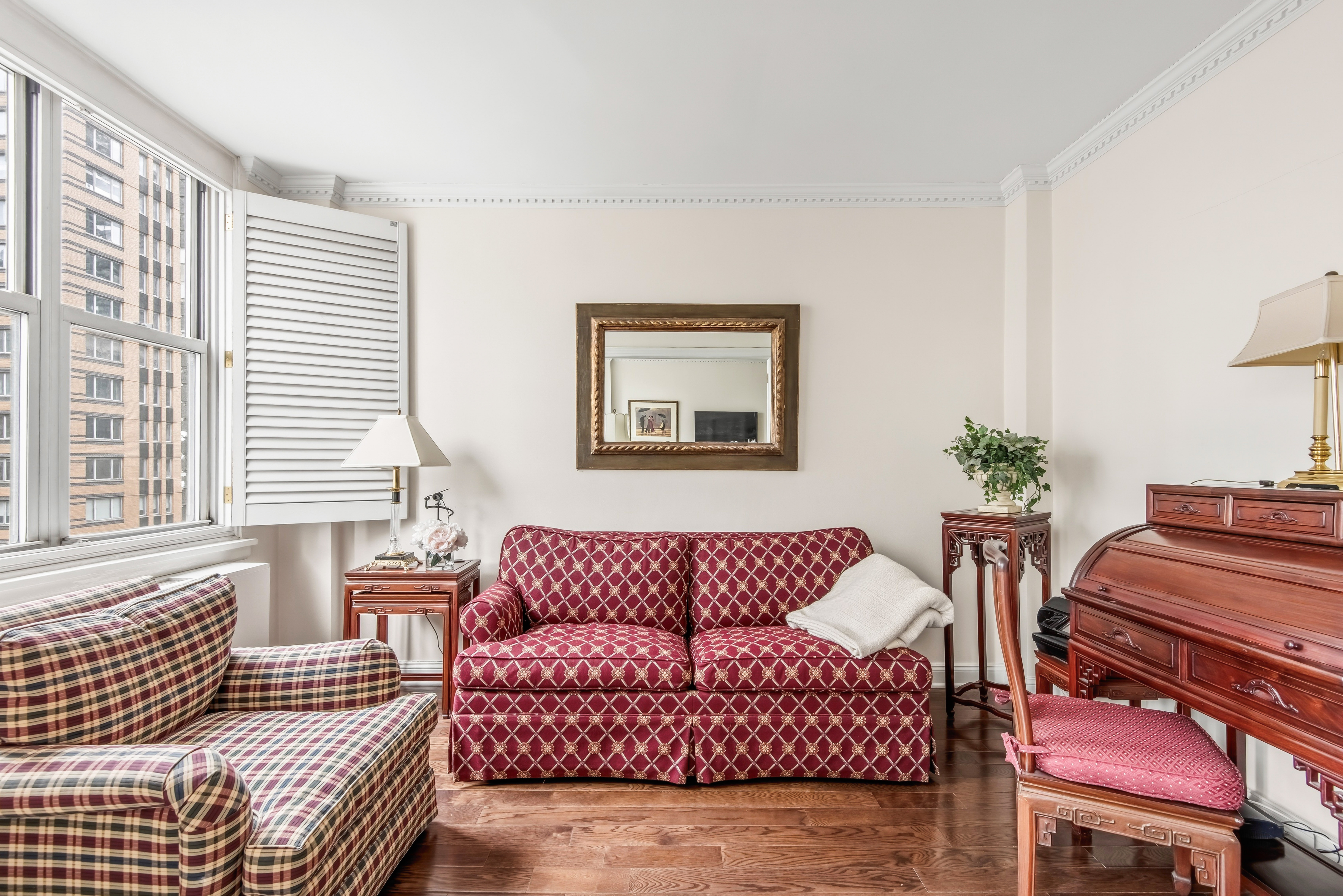 175 East 62nd Street, Unit 14B Manhattan, NY 10065 - Photo 5 of 12 a living room with furniture and a window