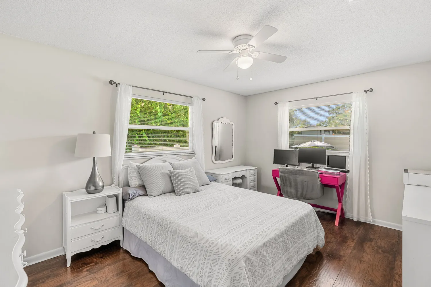 a view of a hallway with window and wooden floor
