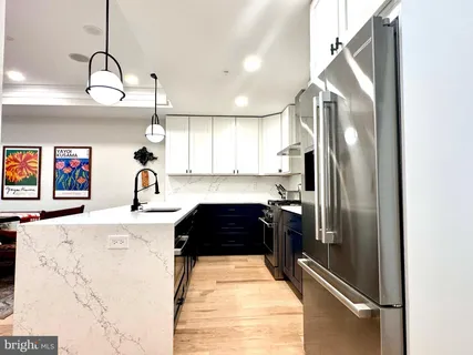 a kitchen with granite countertop a refrigerator and a stove