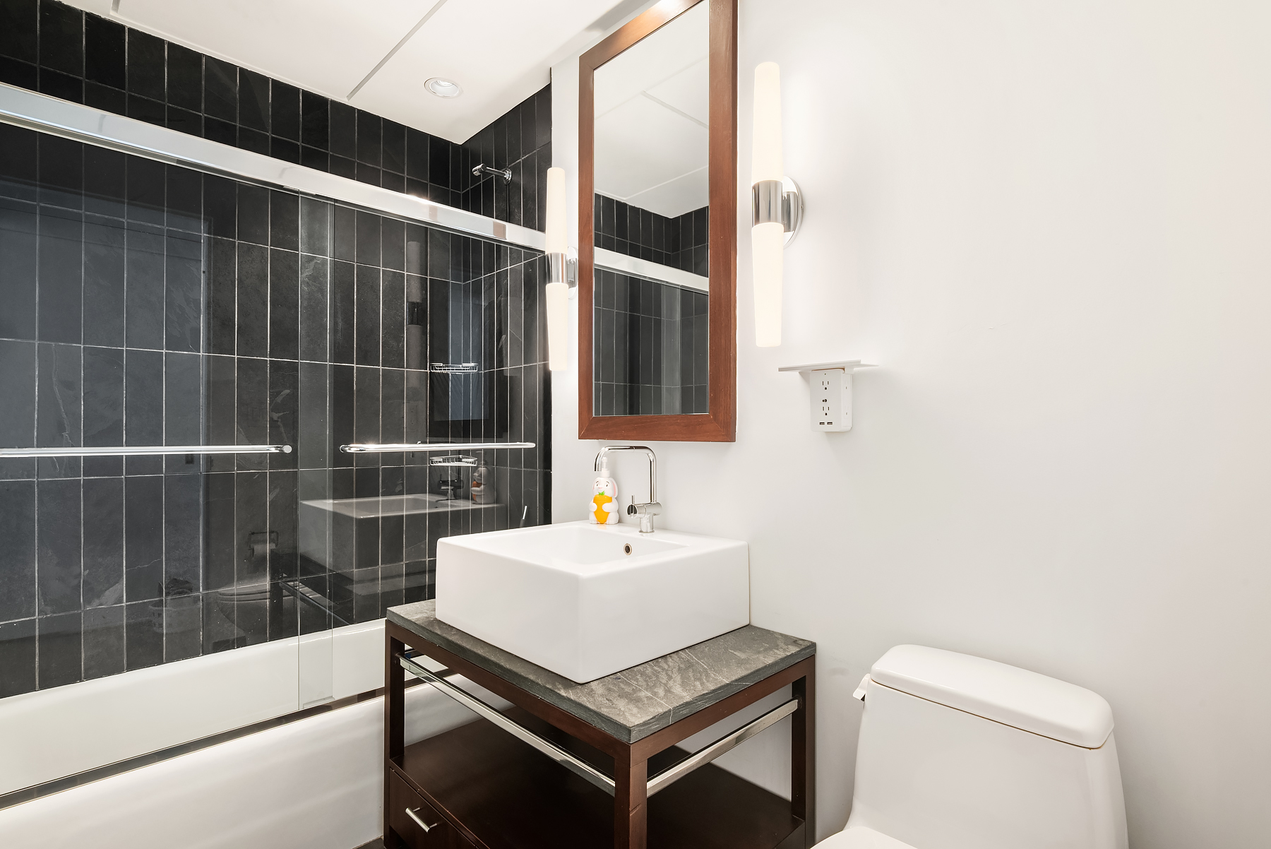 315 West 36th Street, Unit 11D Manhattan, NY 10018 - Photo 6 of 10 a bathroom with a sink toilet and shower