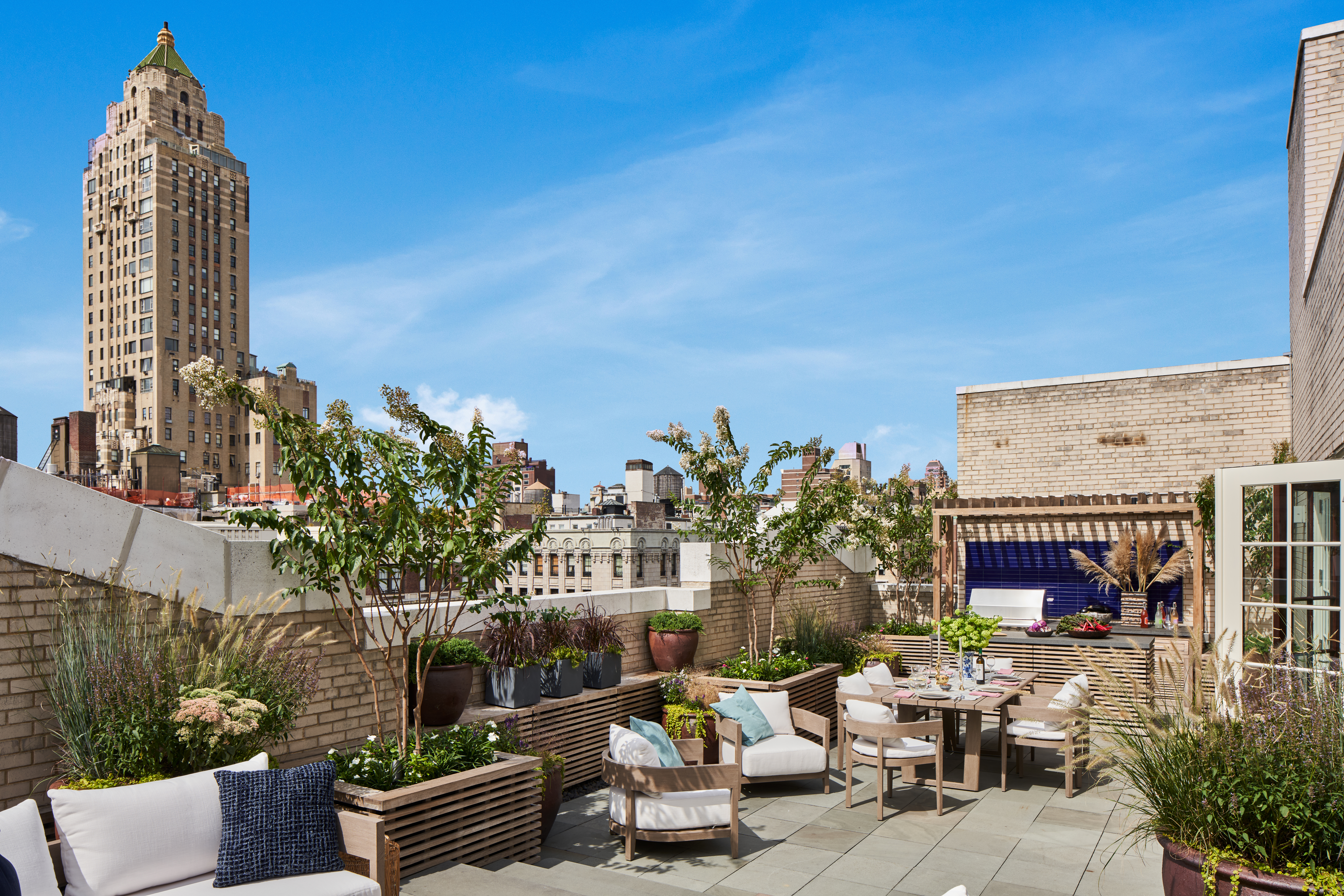 a view of a patio with couches table and chairs and potted plants