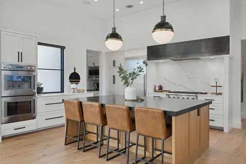 a kitchen with a dining table and chairs