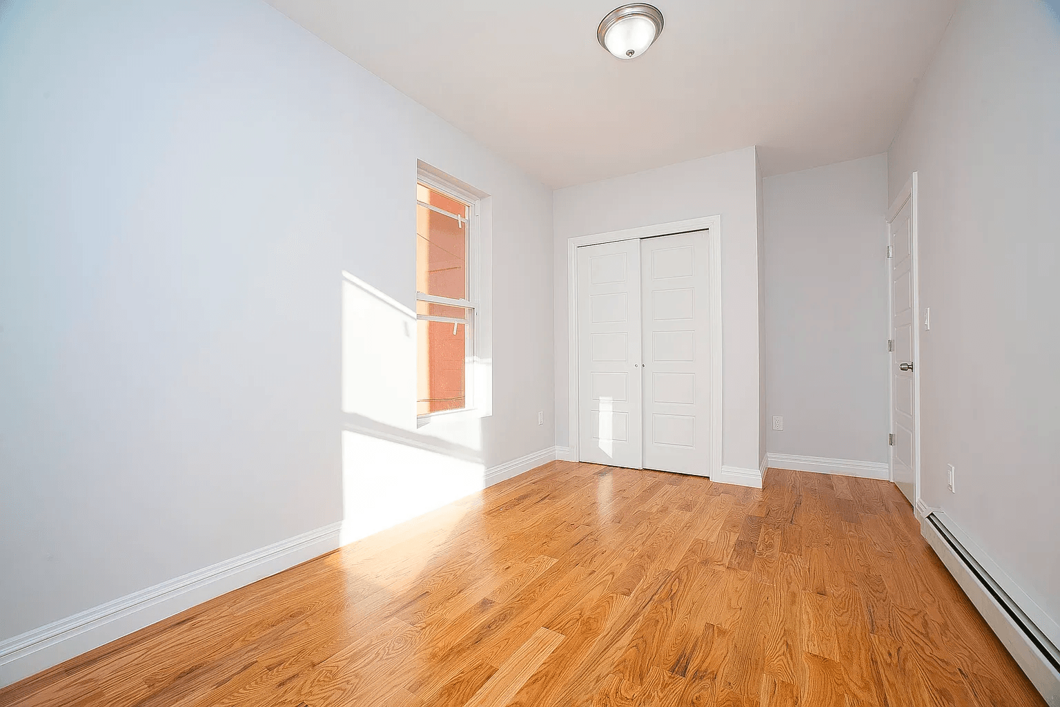 581 Van Siclen Avenue Brooklyn, NY 11207 - Photo 5 of 16 a view of an empty room and window
