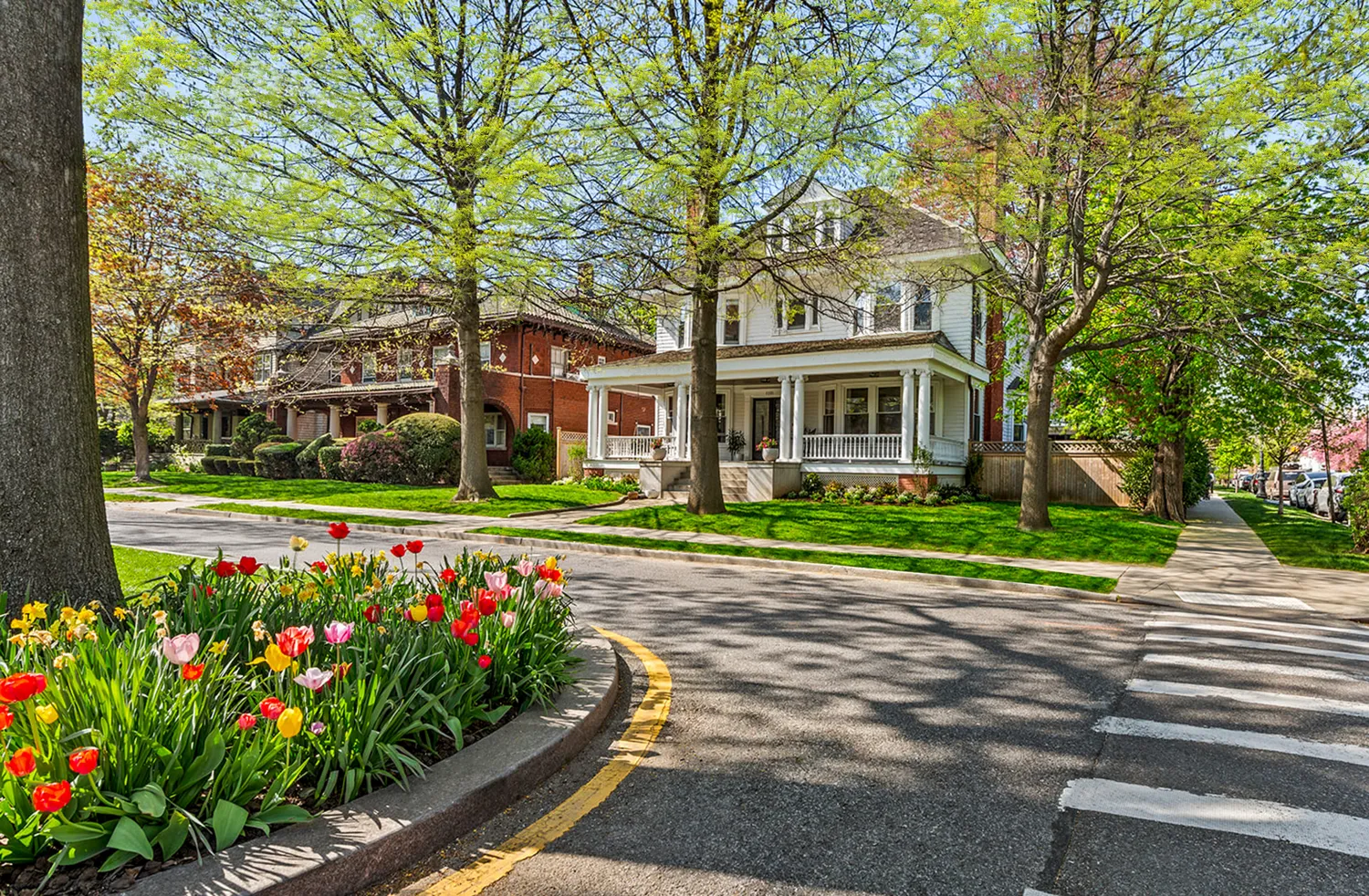 front view of a brick house with a yard