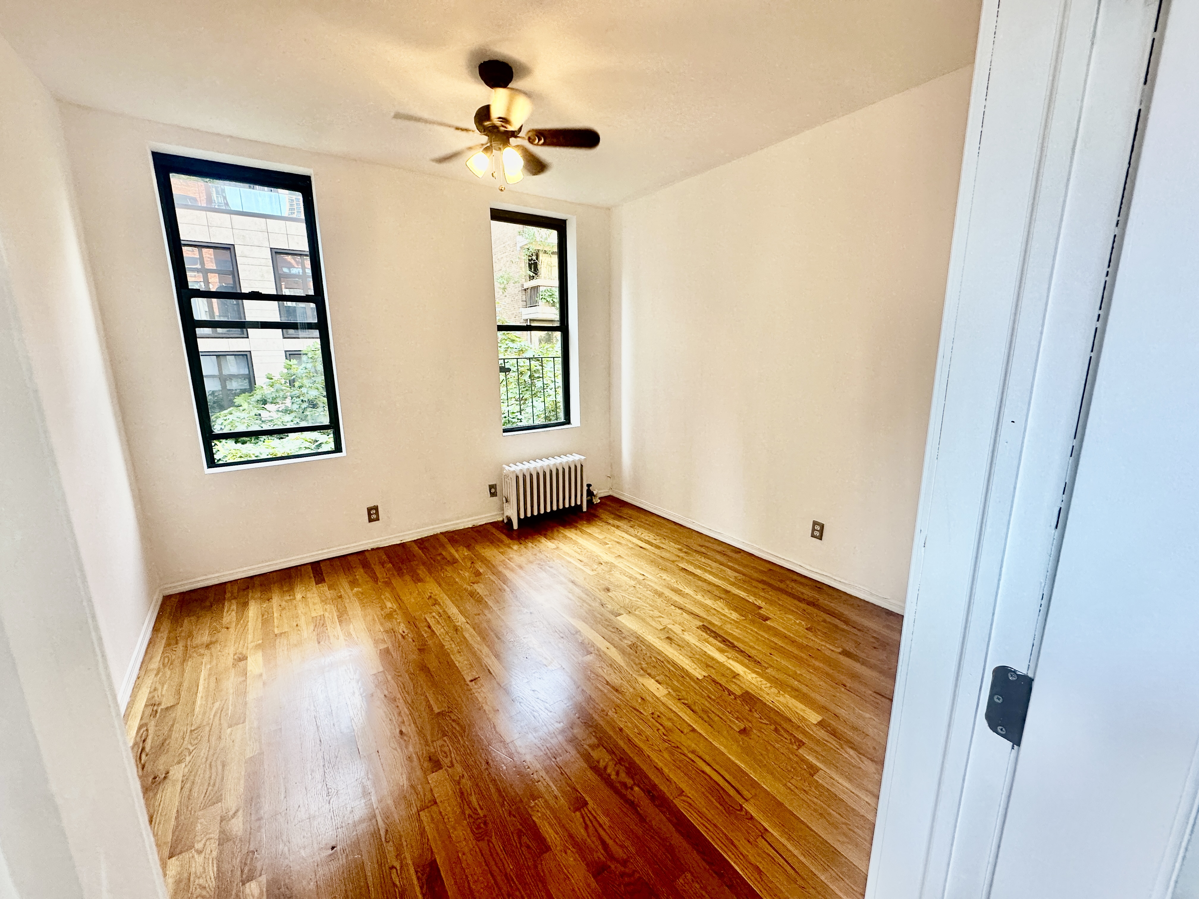 246 East 51st Street, Unit 22 Manhattan, NY 10022 - Photo 4 of 9 a view of a room with wooden floor and window
