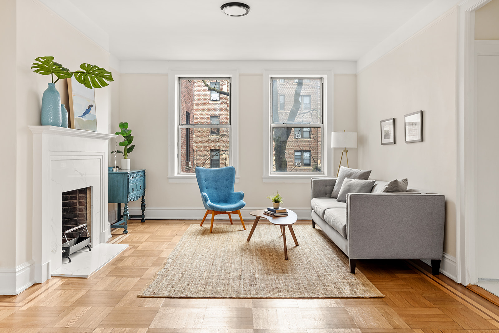 37-16 80th Street, Unit 32 Queens, NY 11372 - Photo 1 of 13 a living room with furniture a fireplace and a potted plant