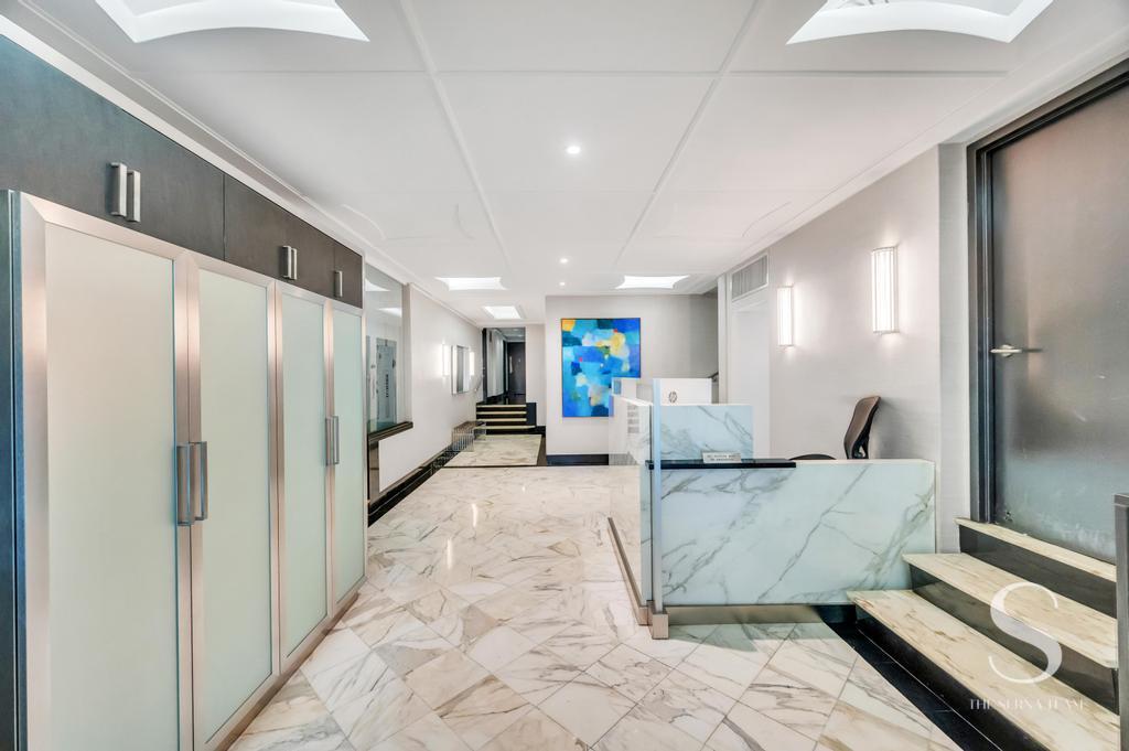 7 Lexington Avenue, Unit 5E Manhattan, NY 10010 - Photo 11 of 14 a large white room with a large window and furniture