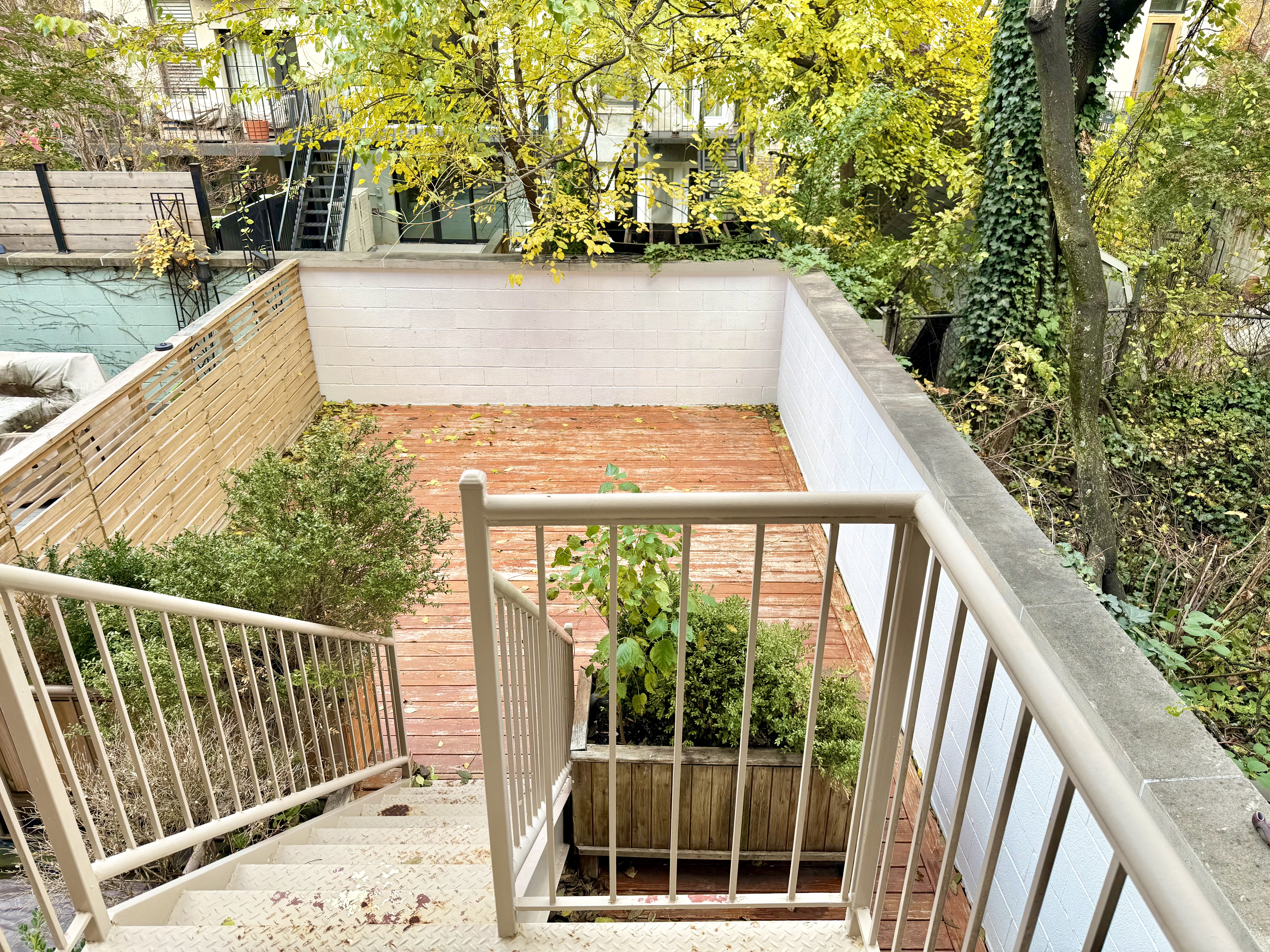 121 West 131st Street, Unit 2 Manhattan, NY 10027 - Photo 8 of 14 a view of balcony with wooden floor and fence