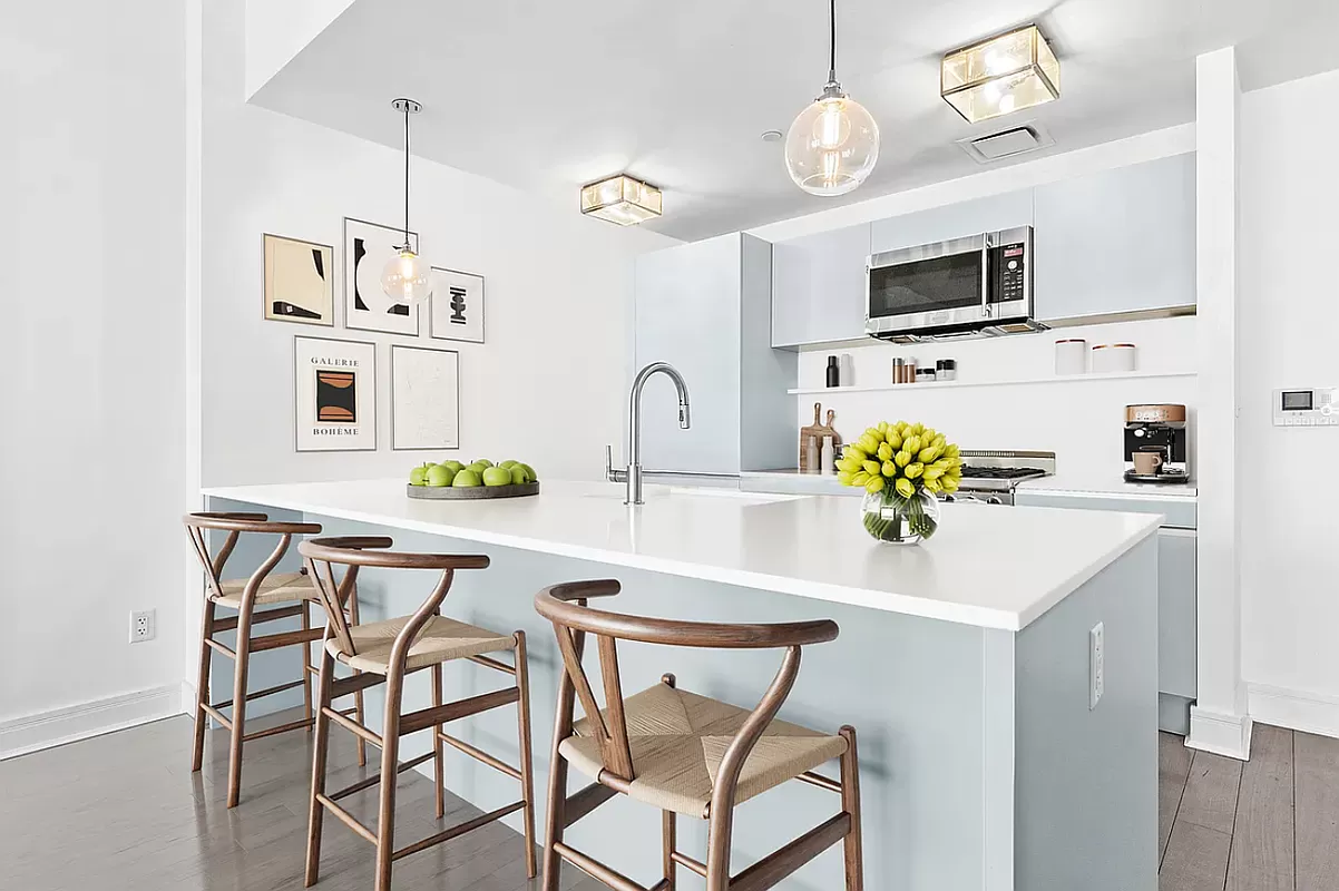 265 State Street, Unit 806 Brooklyn, NY 11201 - Photo 2 of 8 a kitchen with stainless steel appliances a microwave a stove a sink dishwasher and white cabinets with wooden floor