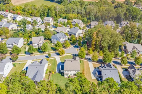 an aerial view of multiple houses with yard
