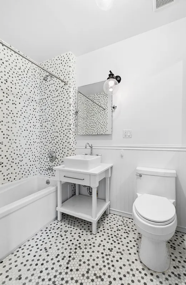180 Bainbridge Street, Unit 407 Brooklyn, NY 11233 - Photo 5 of 22 a bathroom with a toilet a sink and a bathtub