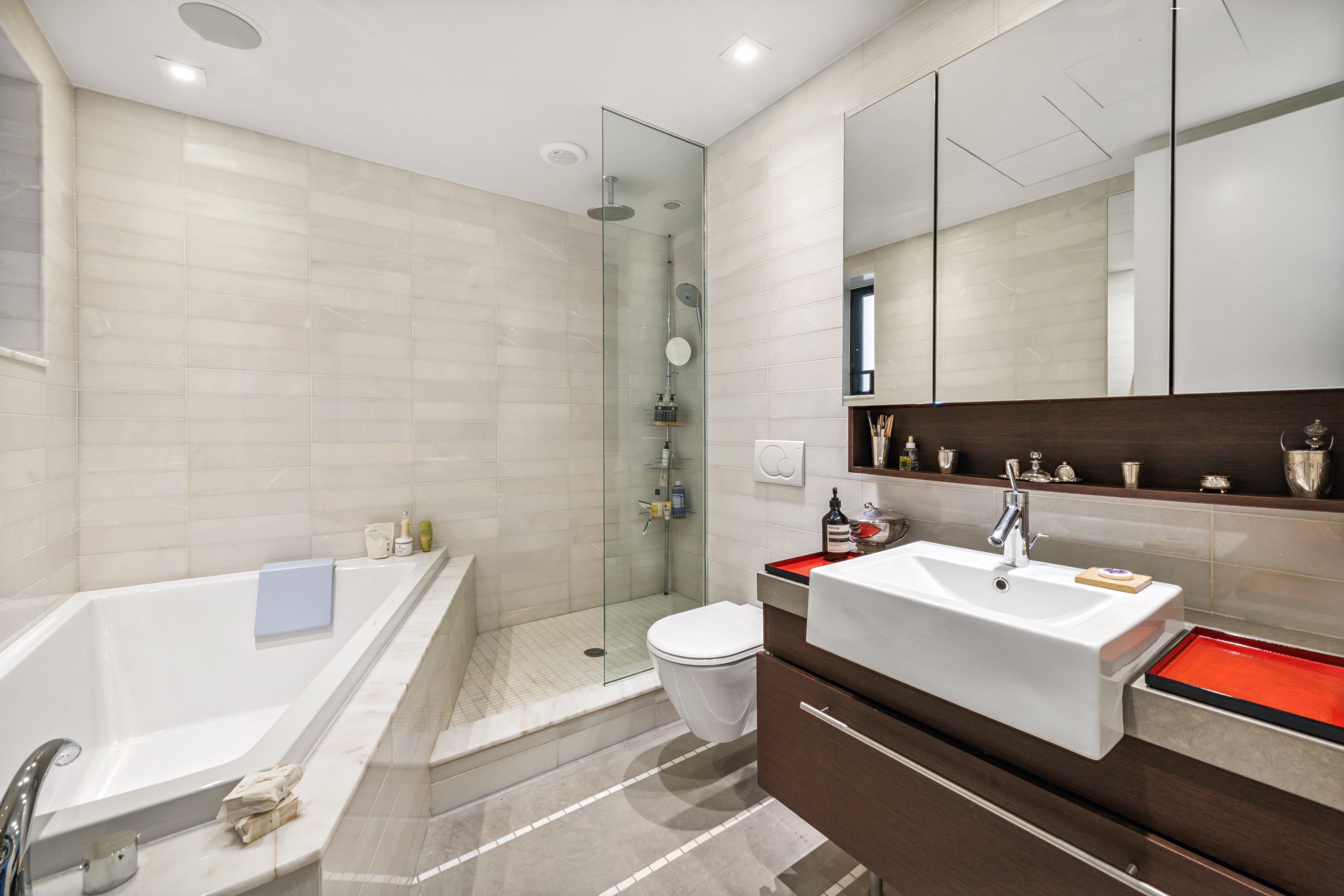 1 West 67th Street, Unit 707 Manhattan, NY 10023 - Photo 14 of 21 a bathroom with a sink a toilet and shower