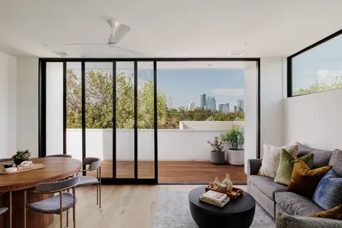 a living room with furniture and a potted plant