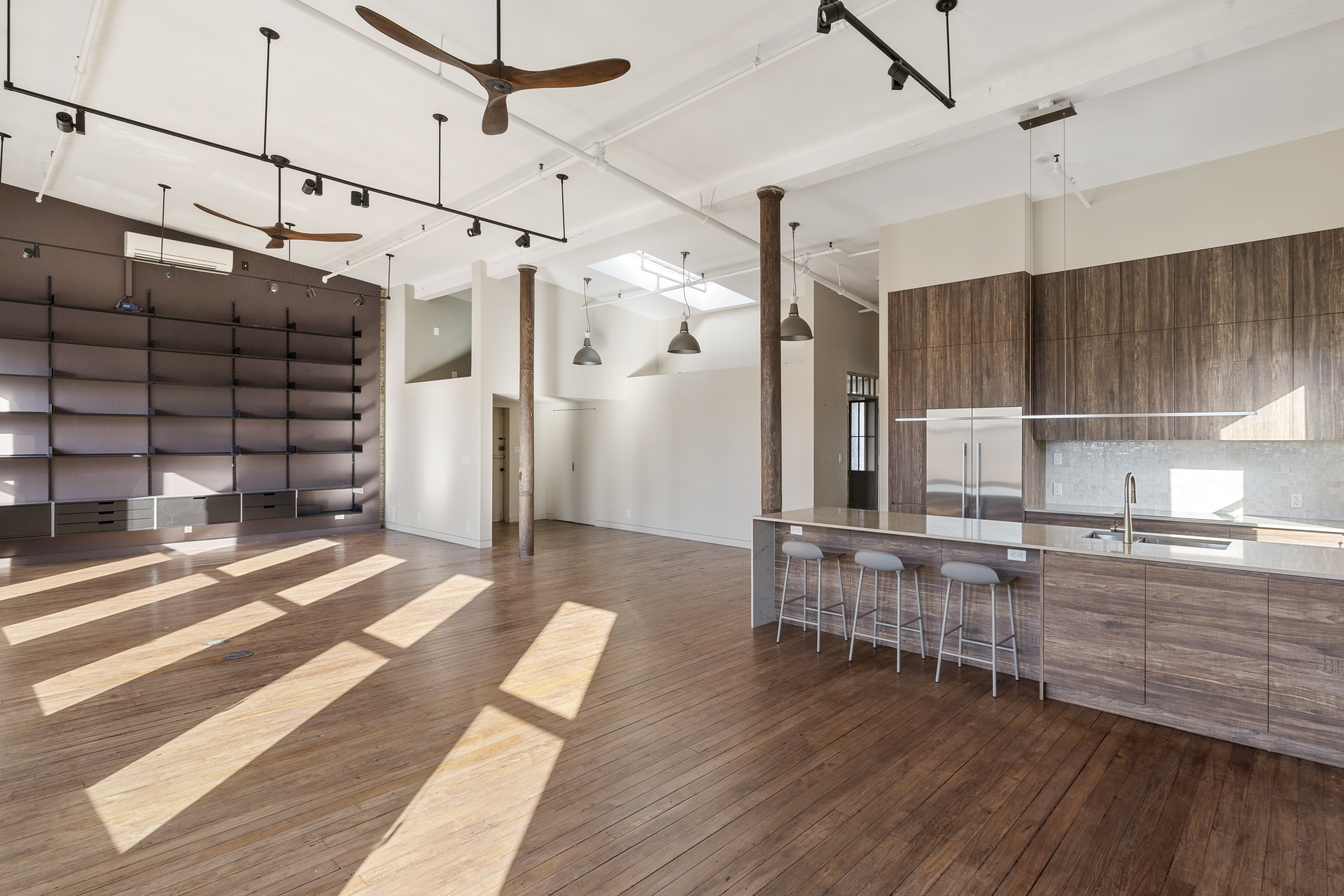 705 Driggs Avenue, Unit 13 Brooklyn, NY 11211 - Photo 3 of 15 a view of a kitchen with wooden floor and a window