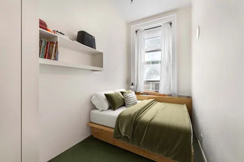 a bedroom with a bed and window