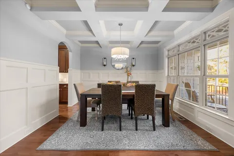 a living room with furniture a fireplace and a chandelier