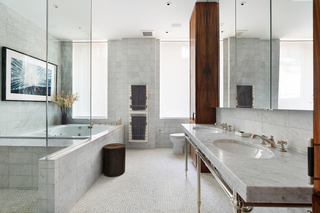 114 Liberty Street, Unit 4 Manhattan, NY 10006 - Photo 10 of 13 a bathroom with a granite countertop double vanity sink a mirror and a bathtub