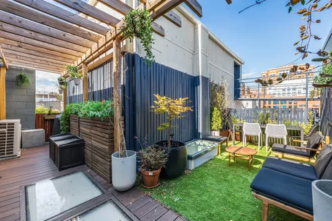 a view of a patio with couches chairs and potted plants
