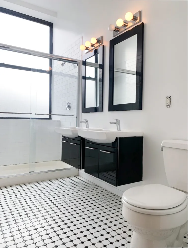a bathroom with a sink vanity mirror and toilet