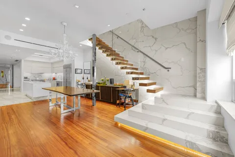 a view of entryway and hall with wooden floor