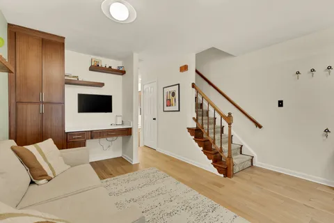 a living room with furniture and wooden floor