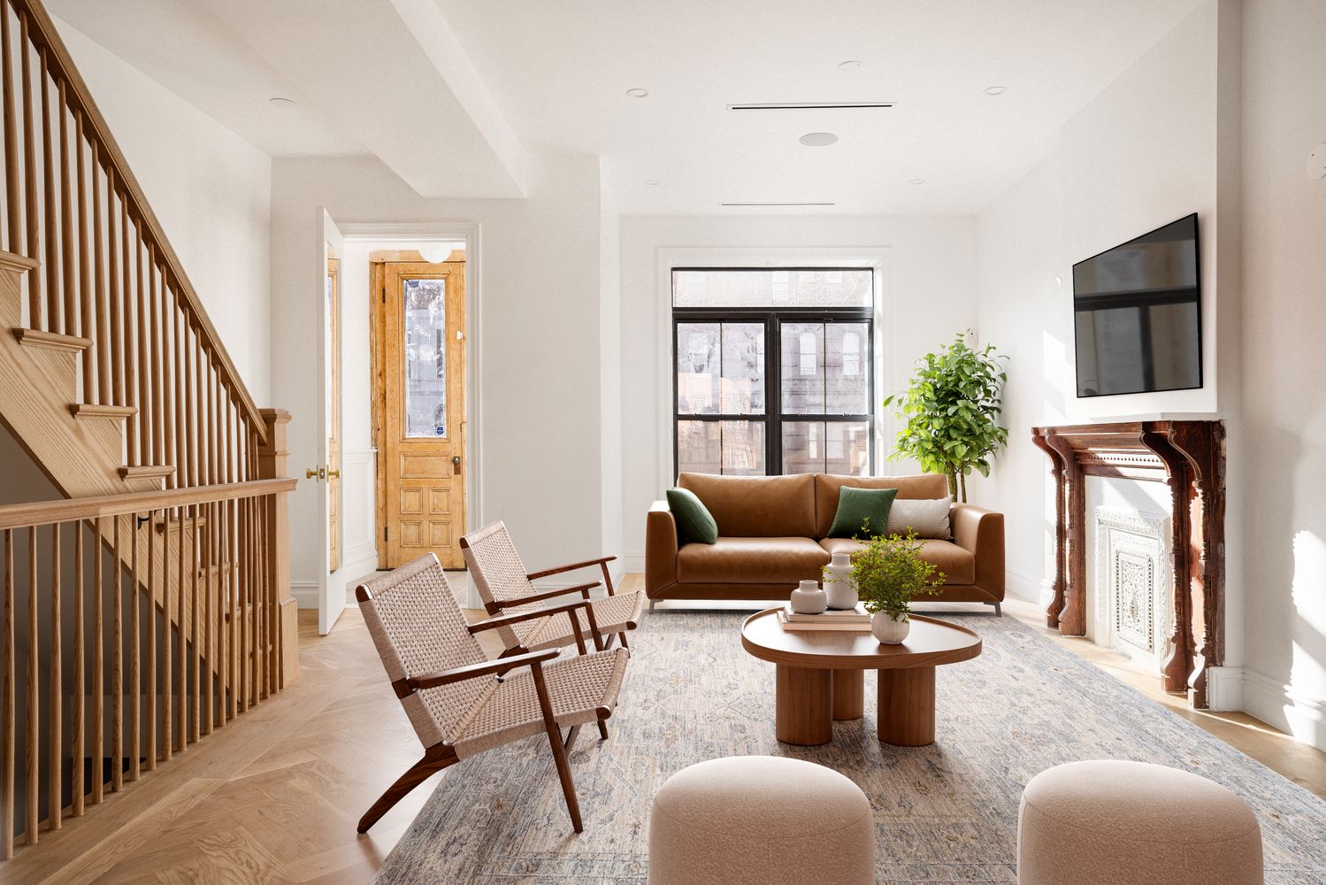 a living room with furniture fireplace and a potted plant