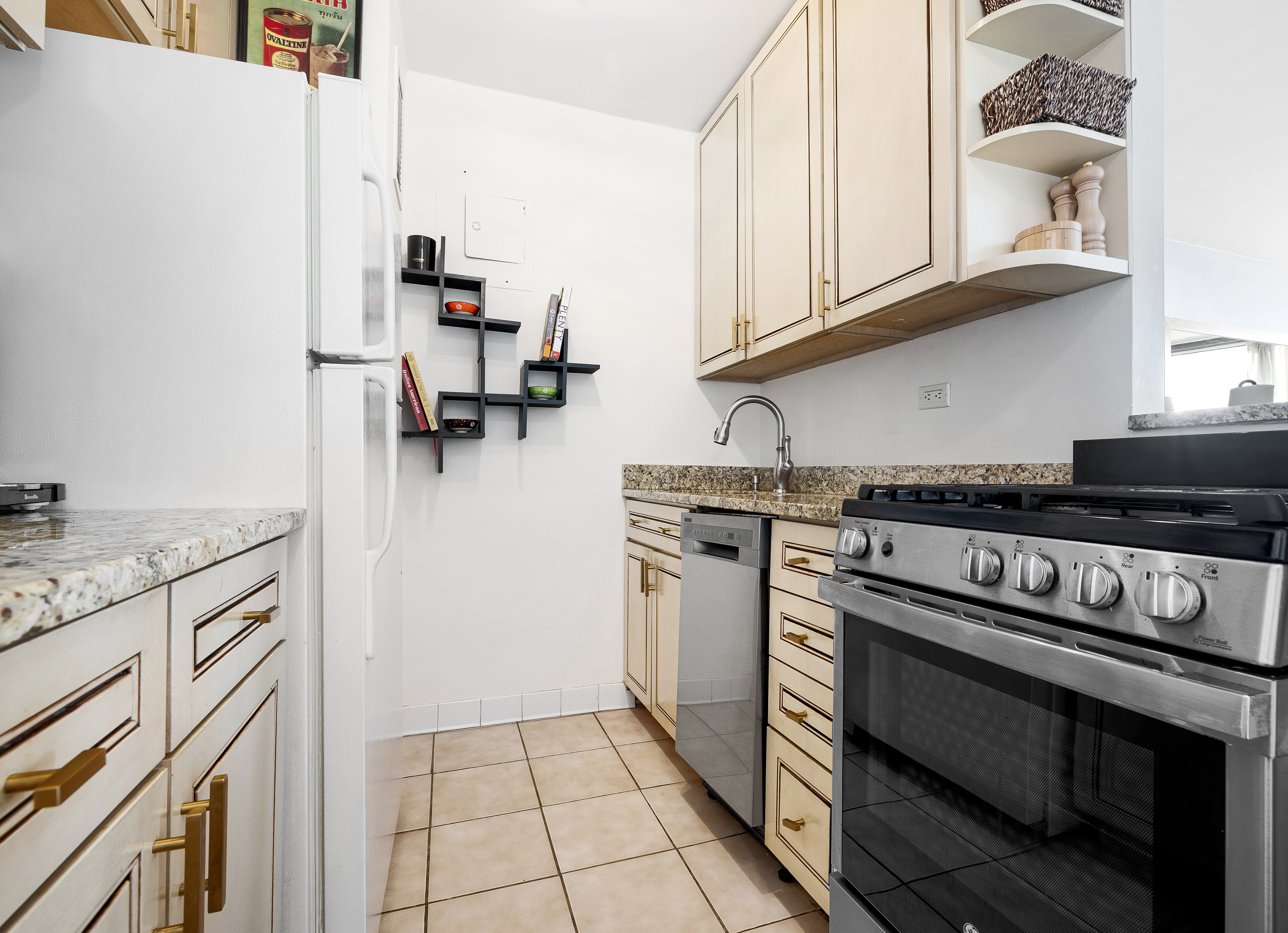 2025 Broadway, Unit 9F Manhattan, NY 10023 - Photo 4 of 11 a kitchen with stainless steel appliances granite countertop a stove and a sink