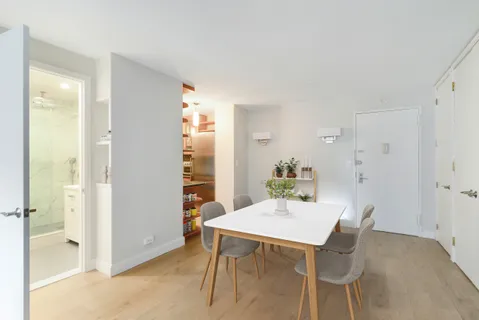 a view of a dining room with furniture and a livingroom
