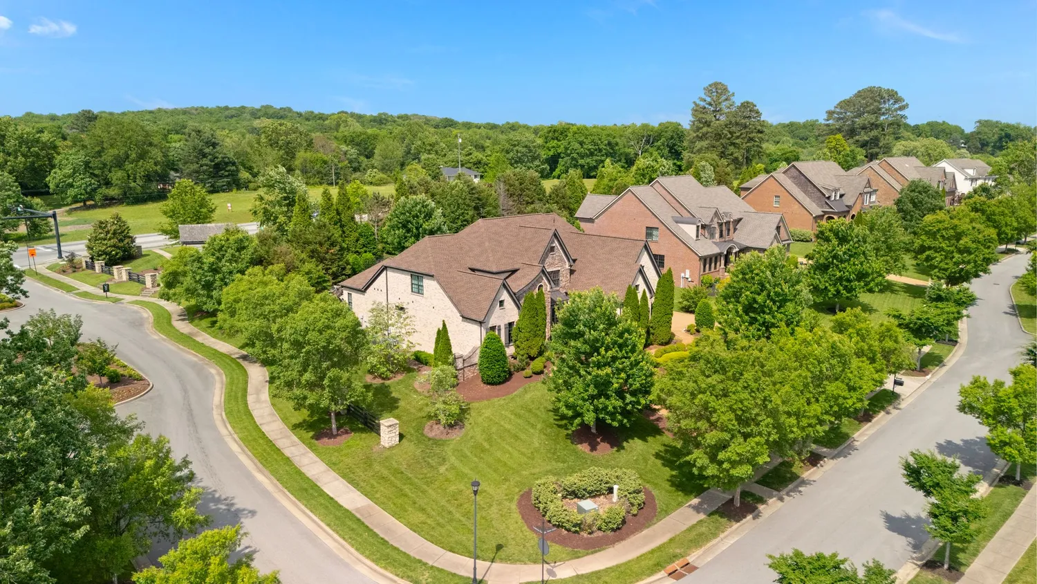 an aerial view of residential houses with outdoor space and street view