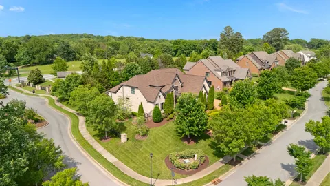 an aerial view of residential houses with outdoor space and street view