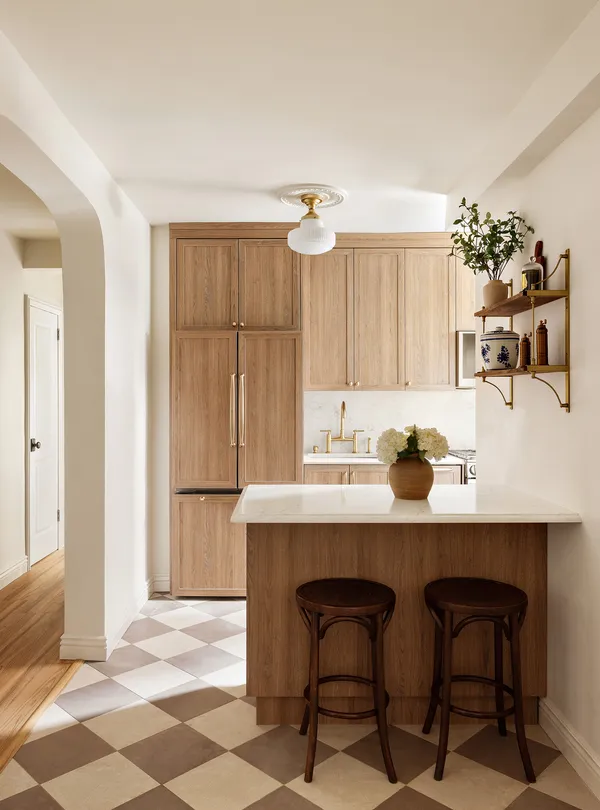 a view of a kitchen with a dining table and chairs