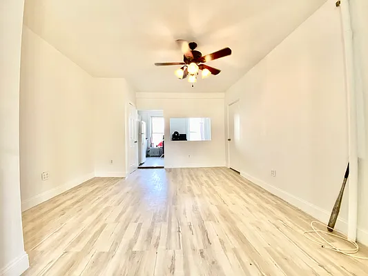 591 Vanderbilt Avenue, Unit 4 Brooklyn, NY 11238 - Photo 1 of 10 a view of a room with wooden floor and ceiling fan