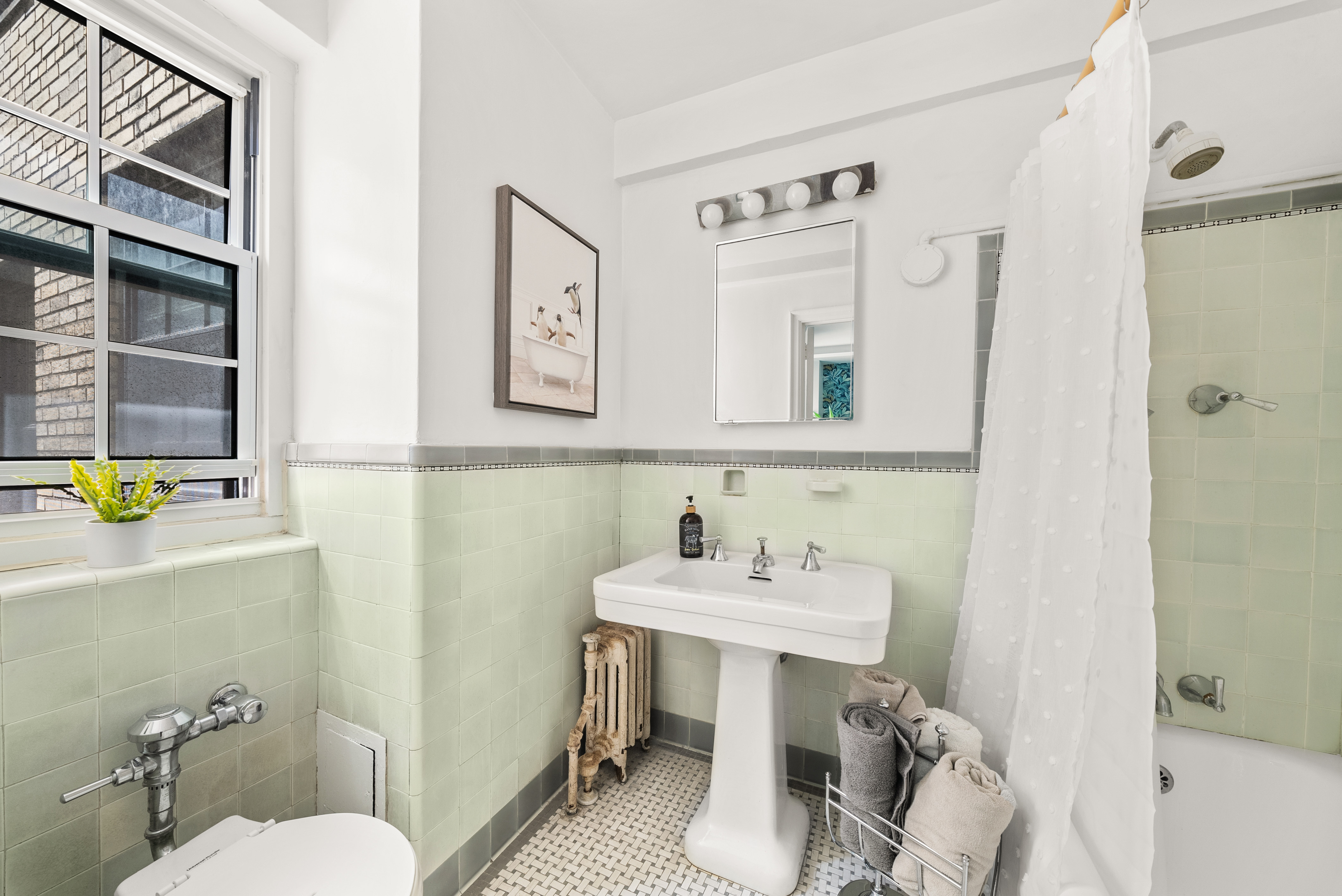 12 East 88th Street, Unit 9C Manhattan, NY 10128 - Photo 7 of 9 a bathroom with a sink mirror and toilet