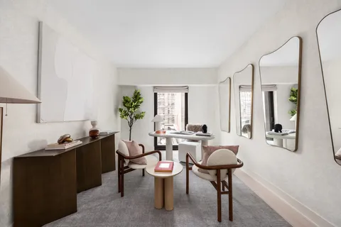 a living room with furniture a window and a table