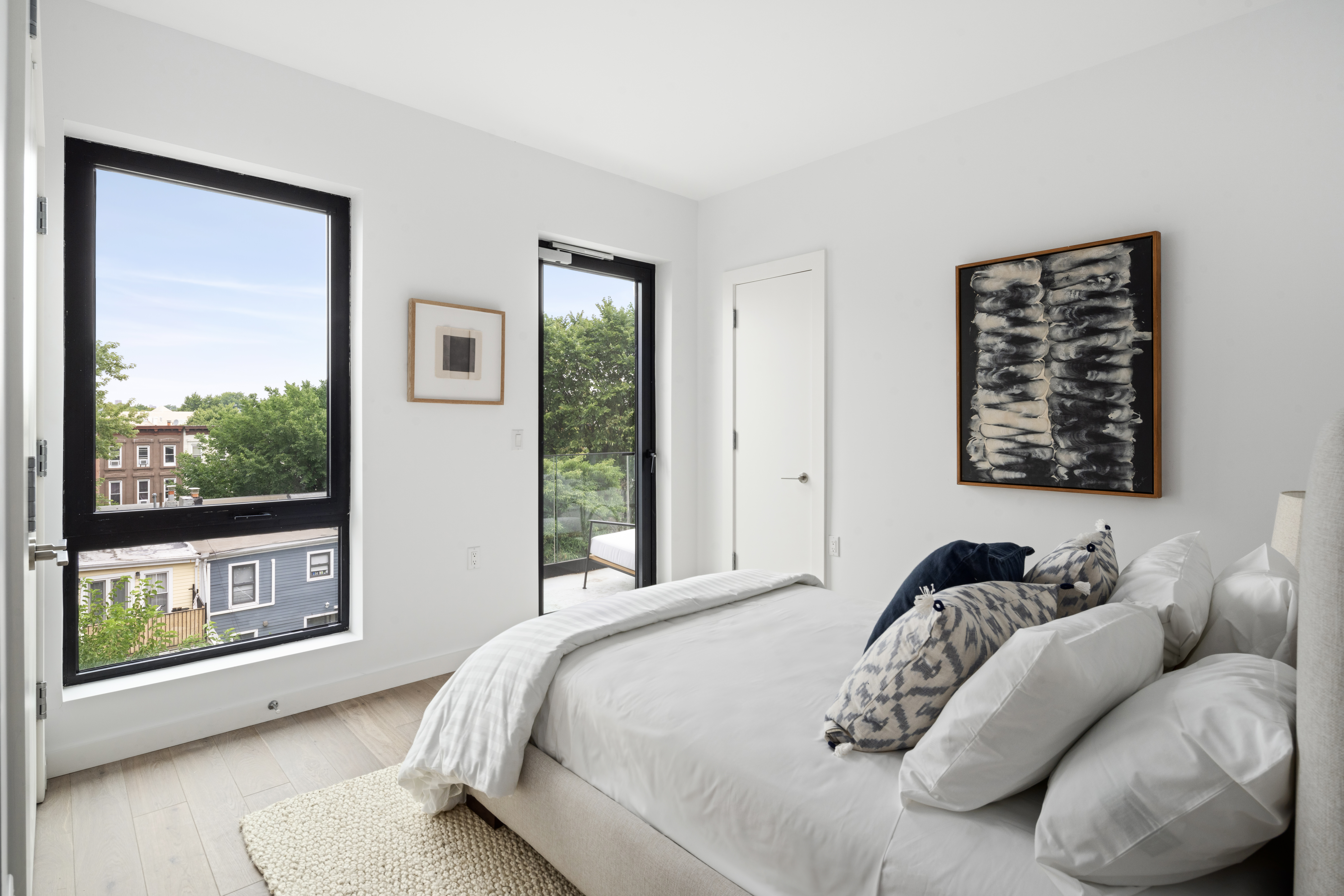 435 Tompkins Avenue, Unit PH505 Brooklyn, NY 11216 - Photo 5 of 14 a bedroom with a bed and a large window