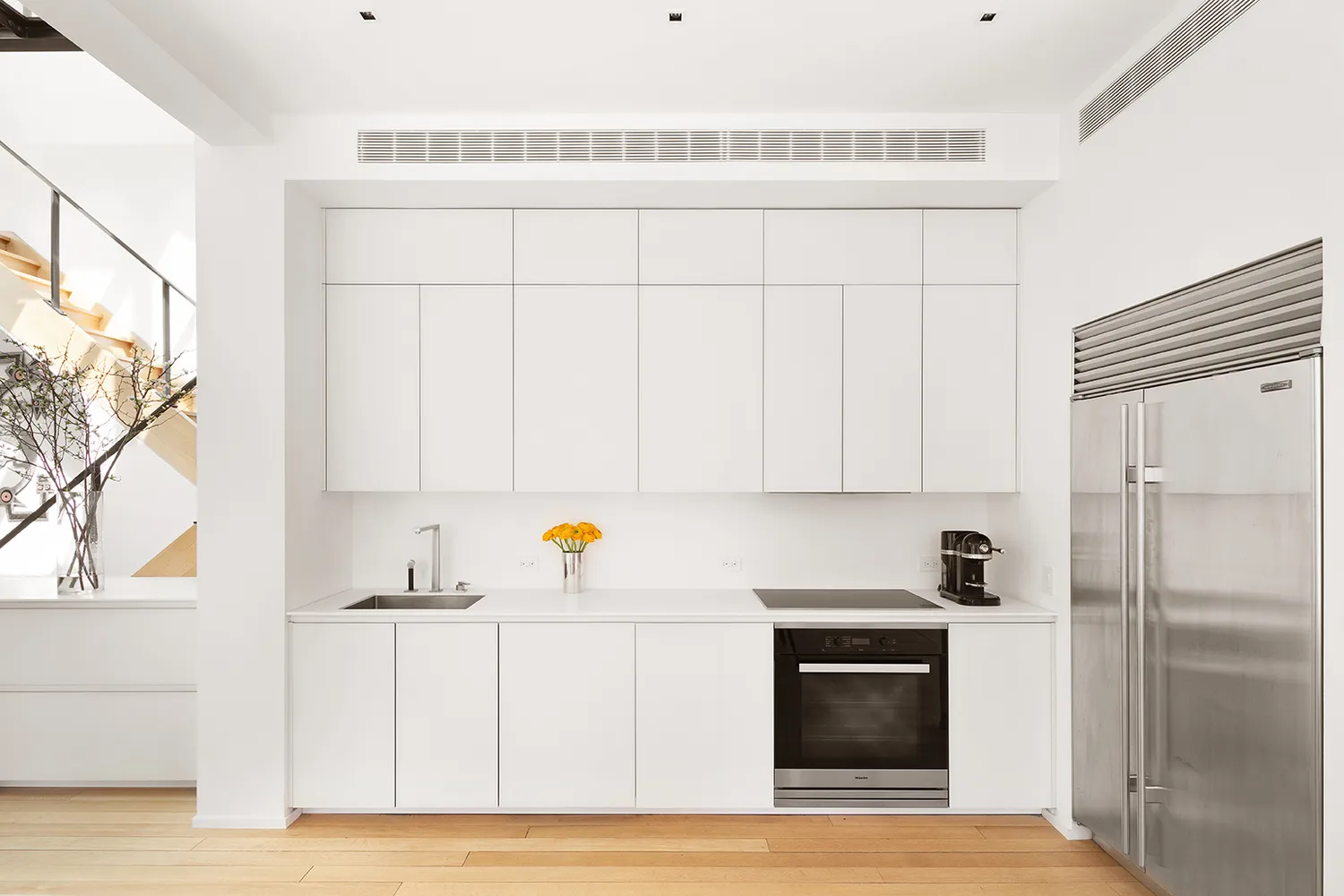 a kitchen with a sink cabinets and stainless steel appliances