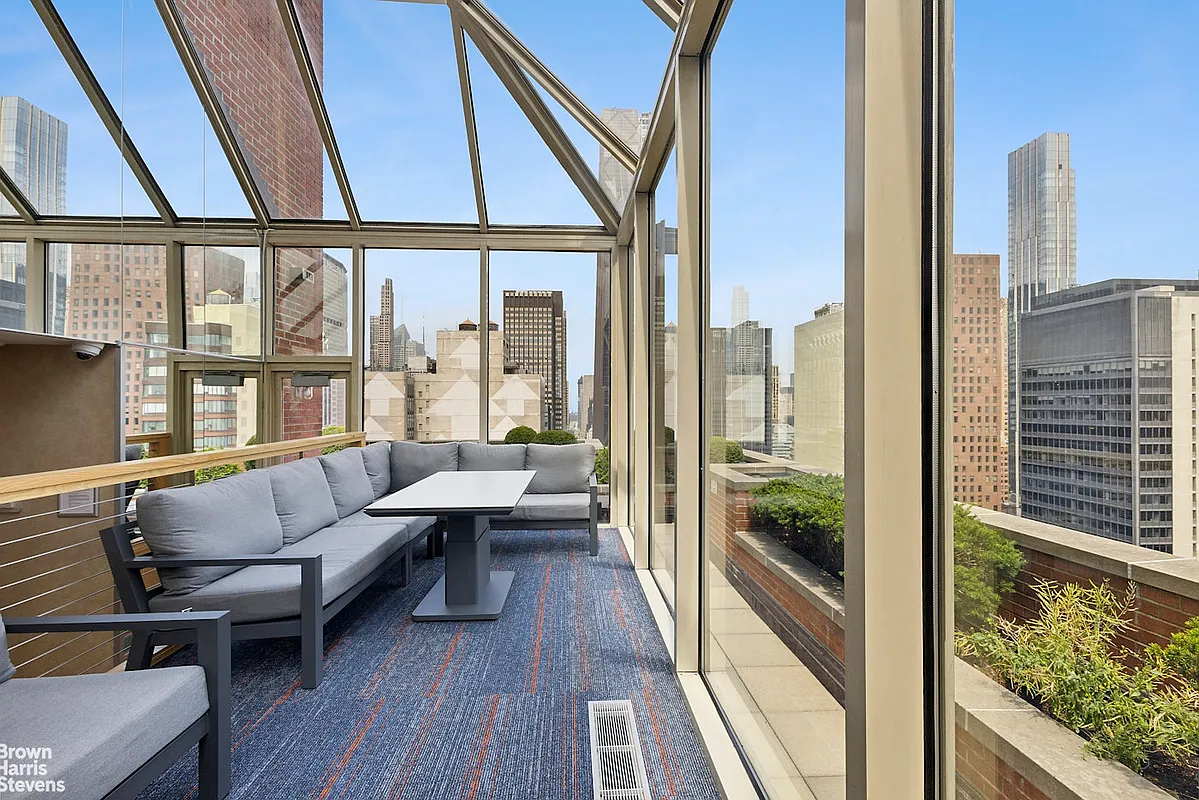 236 East 47th Street, Unit 27DE Manhattan, NY 10017 - Photo 13 of 16 a living room with furniture and a large window
