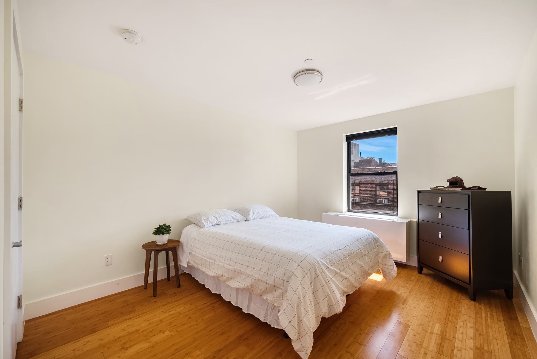 234 West 148th Street, Unit 5C Manhattan, NY 10039 - Photo 6 of 15 a bedroom with a bed and a closet
