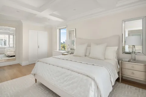 a bedroom with a bed and a night stand