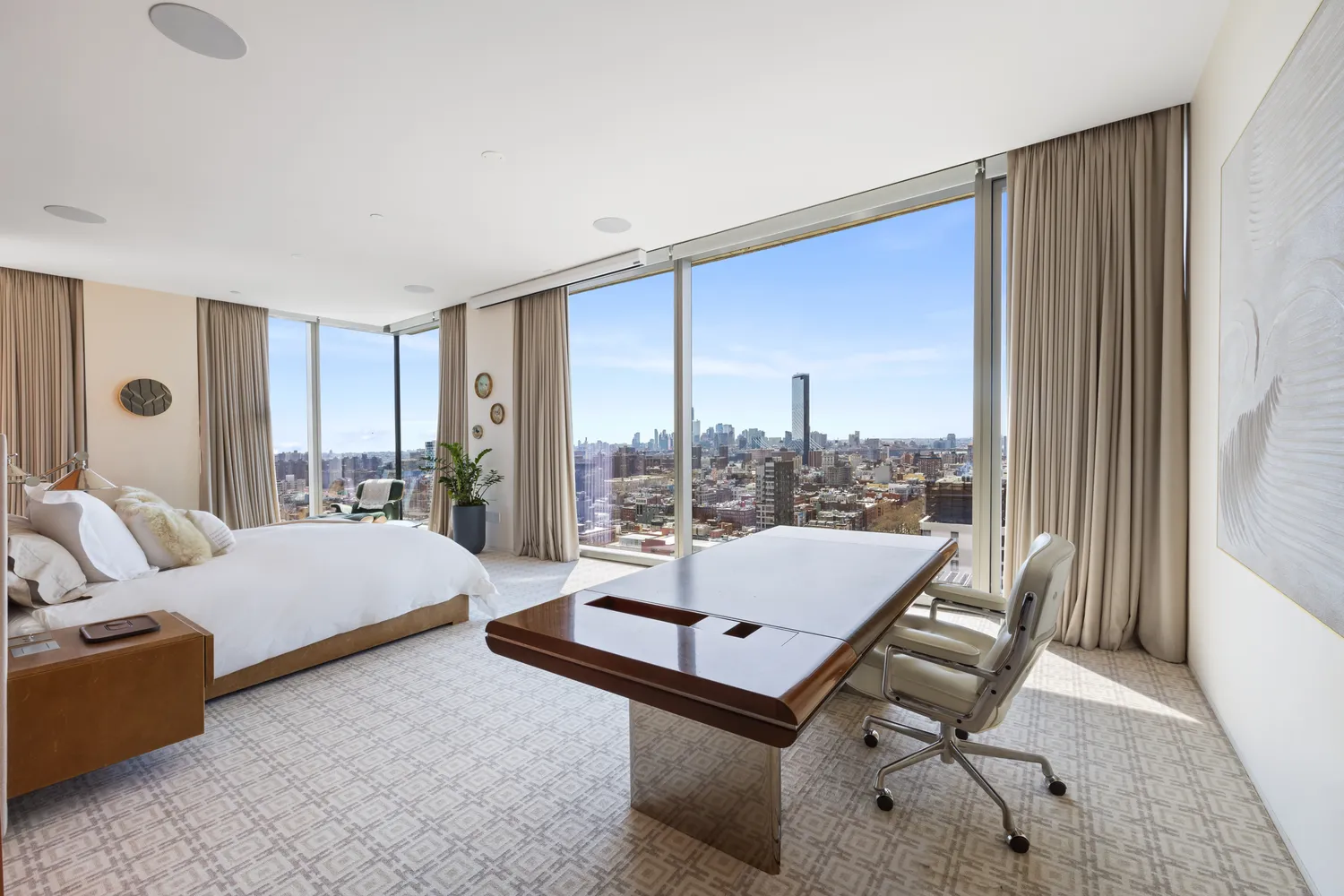 a bedroom with a large bed and a large window
