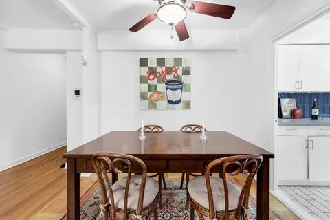 a view of a dining room with furniture and chandelier