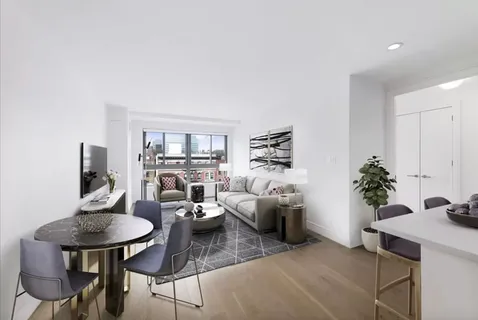 a living room with furniture potted plant and a table