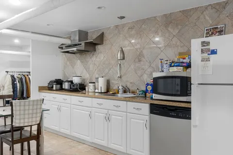 a kitchen with cabinets and white appliances